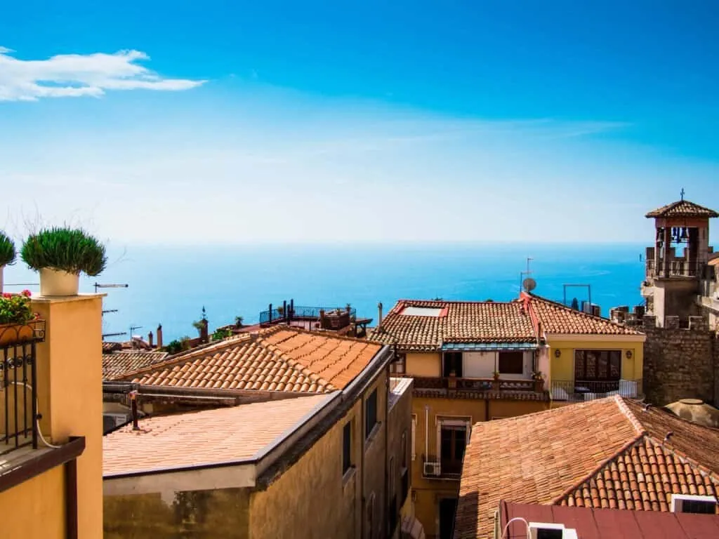 Terracotta rooftops and the bell tower over the Ionian