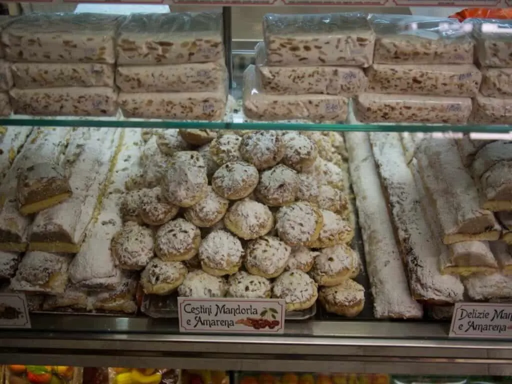 Cassatelle and almond pastries behind the counter glass