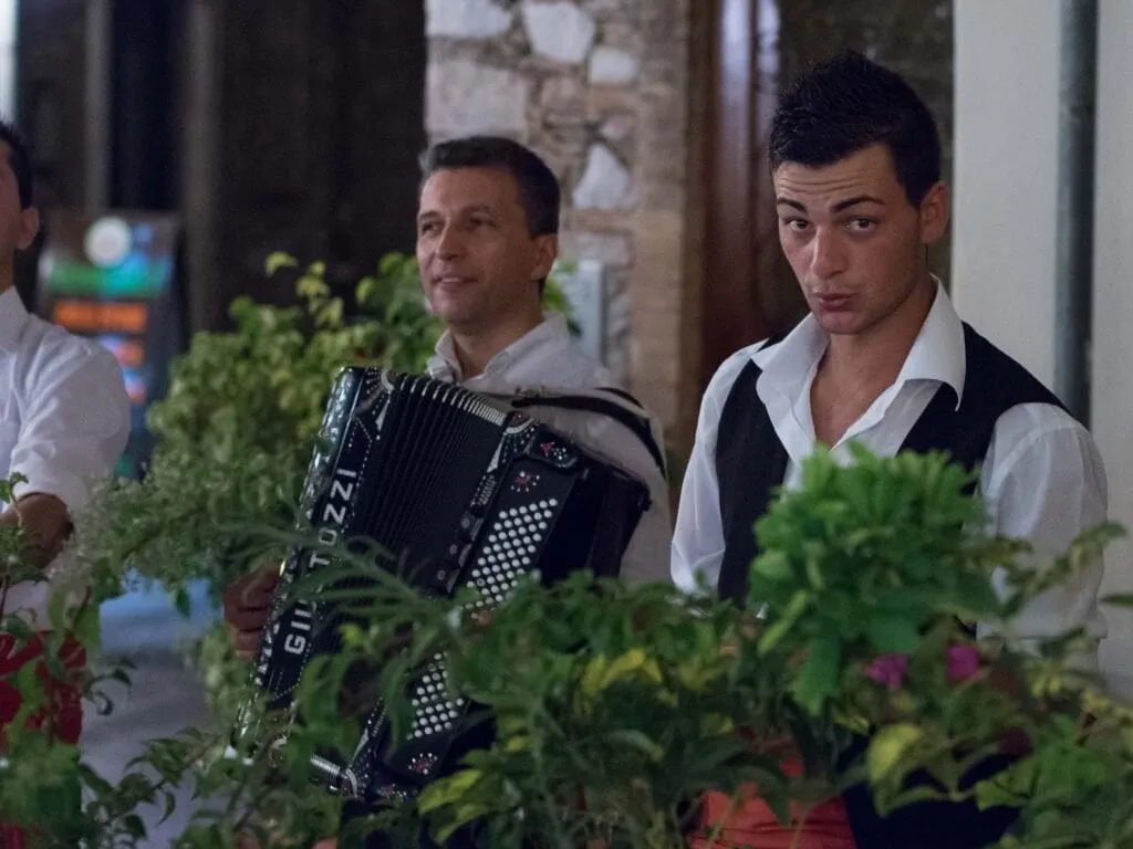 An accordionist works the restaurant terraces on Corso Umberto
