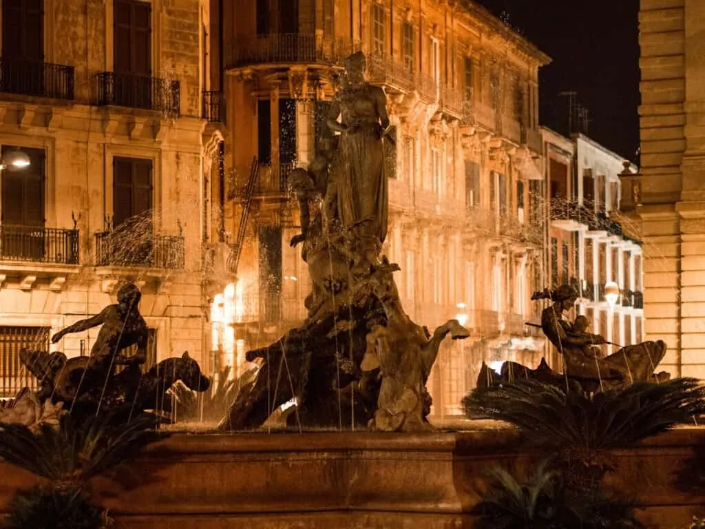 The Fontana di Diana lit gold against the palazzi