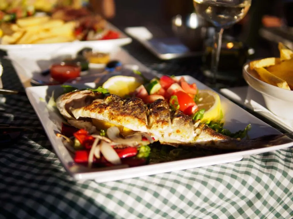 Grilled sea bass on a green-check tablecloth at the Vineyard Taverna