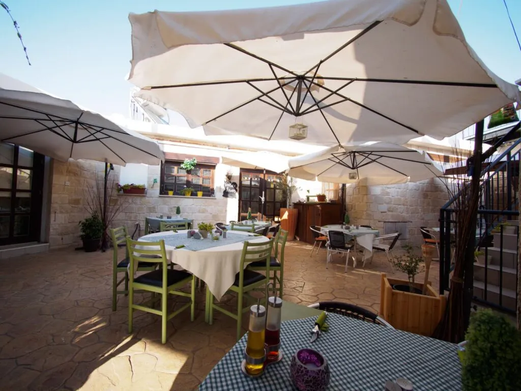 The taverna terrace under its umbrellas, Letymbou rooftops beyond