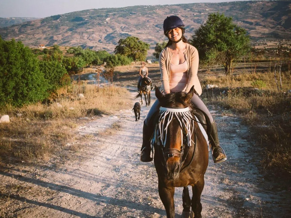 Riding out from the stables, farm dog alongside