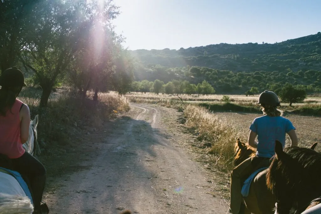 Two riders on the dirt track through the hills near Melandra