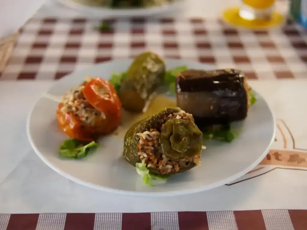 Gemista — stuffed tomato, pepper and aubergine — on a gingham tablecloth at Laona