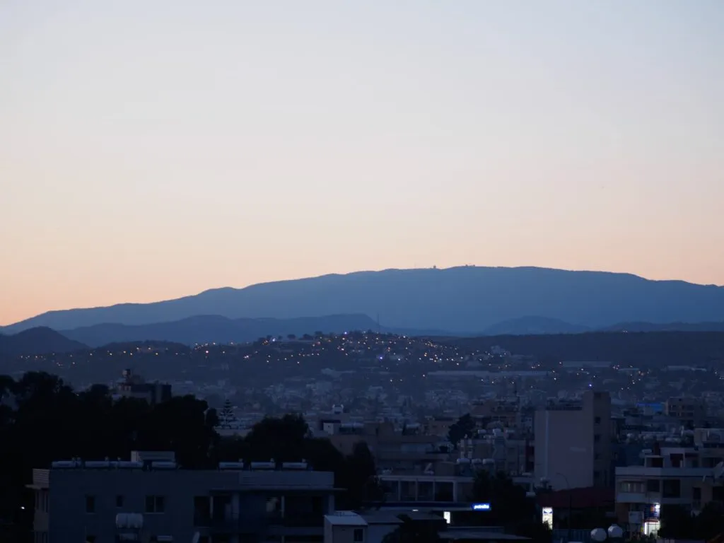 Limassol at dusk, the hills behind the rooftops