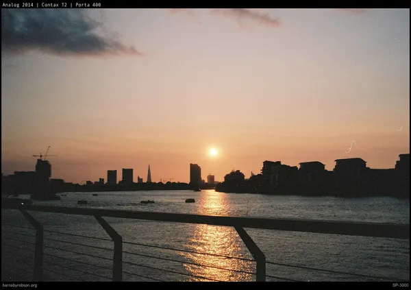 Sunset over River Thames, London skyline silhouetted, including The Shard.