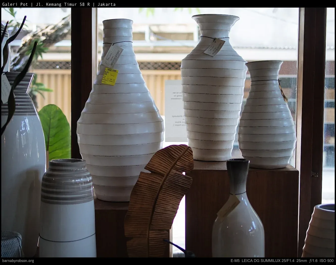A row of white ceramic vases in the Galeri Pot workshop, Kemang Timur.