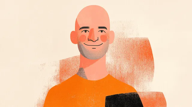 Smiling bald man with stubble wearing an orange t-shirt.