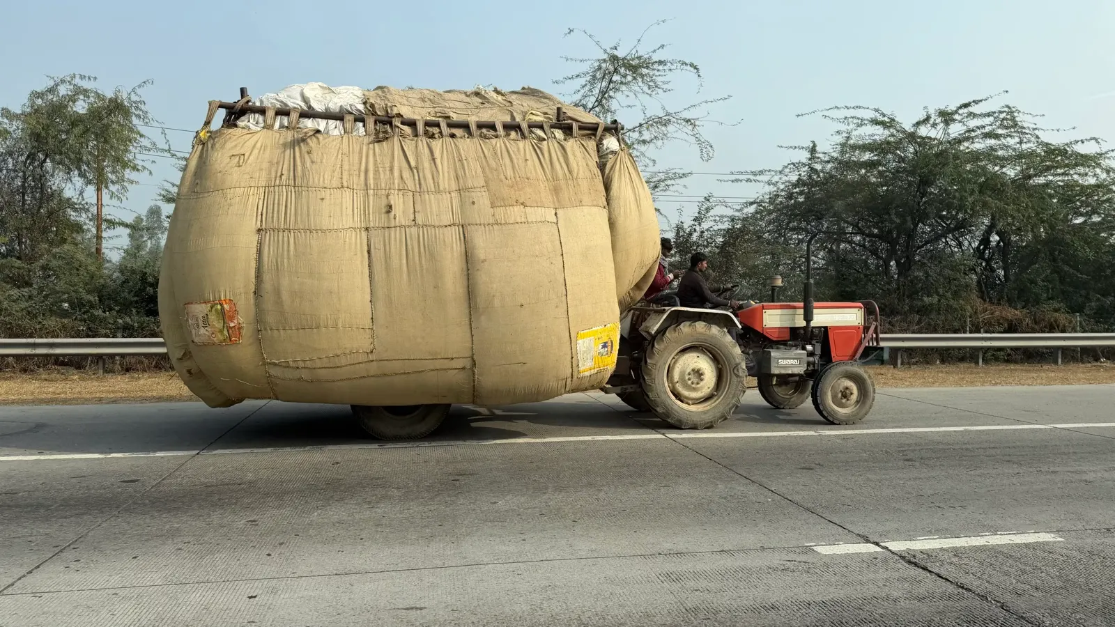 Overloaded tractor on Indian highway