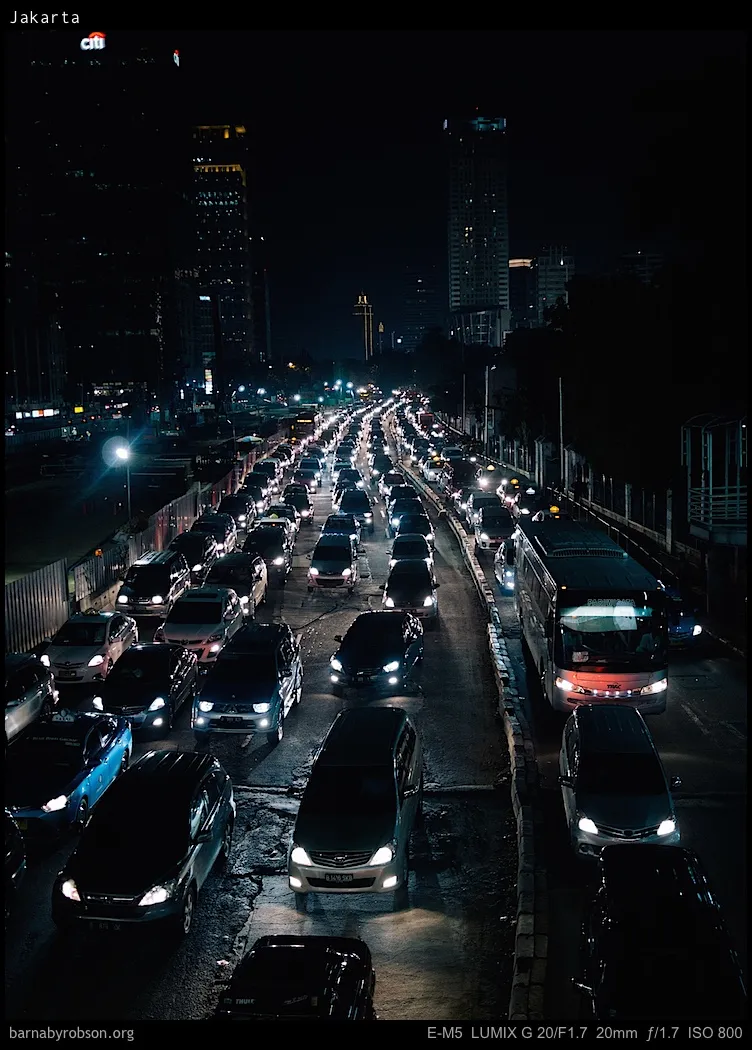 Night-time traffic jam on a multi-lane road in Jakarta city.