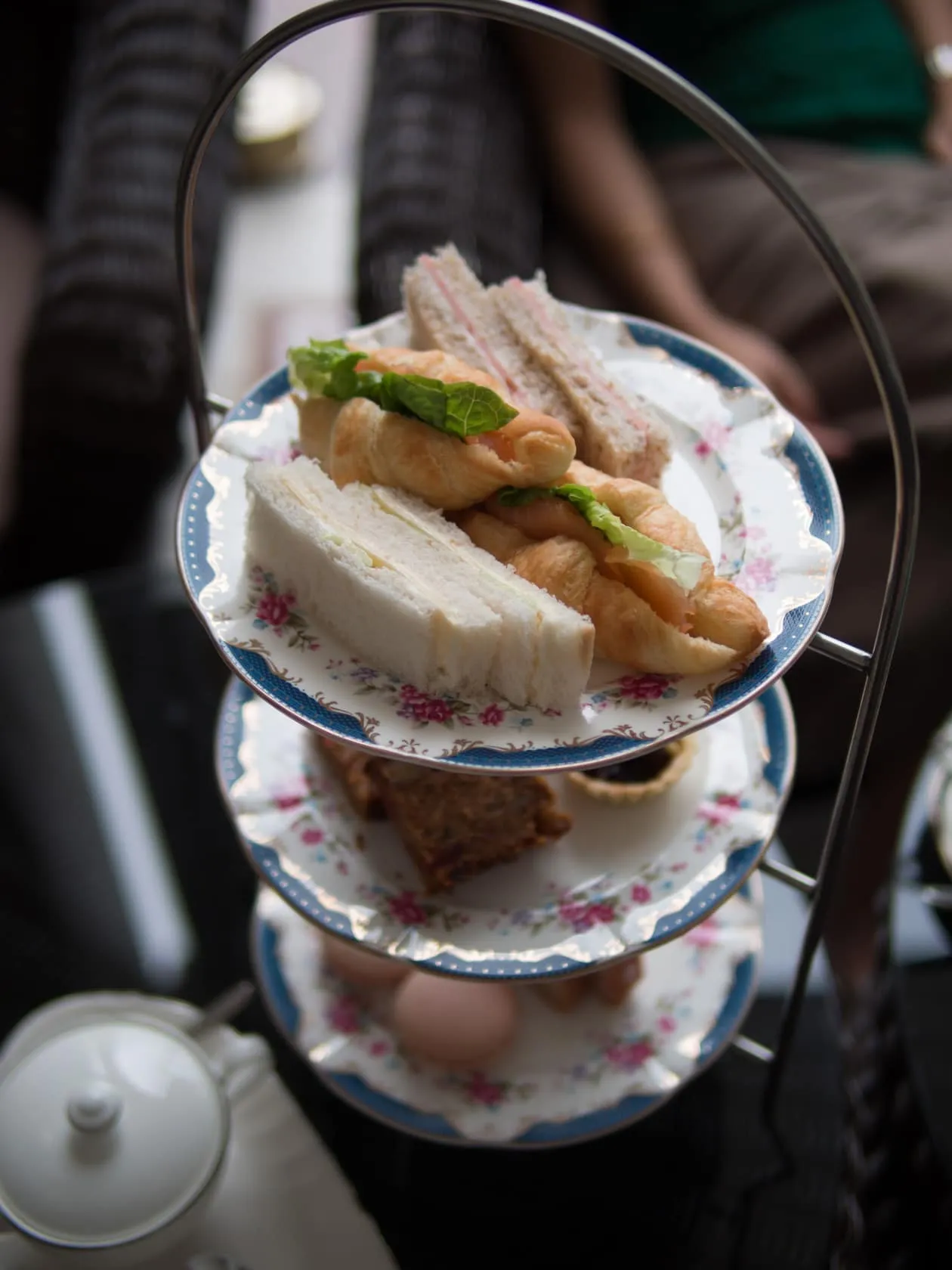 Three-tier afternoon-tea stand at Carcosa Seri Negara, finger sandwiches and salmon croissants on the top plate