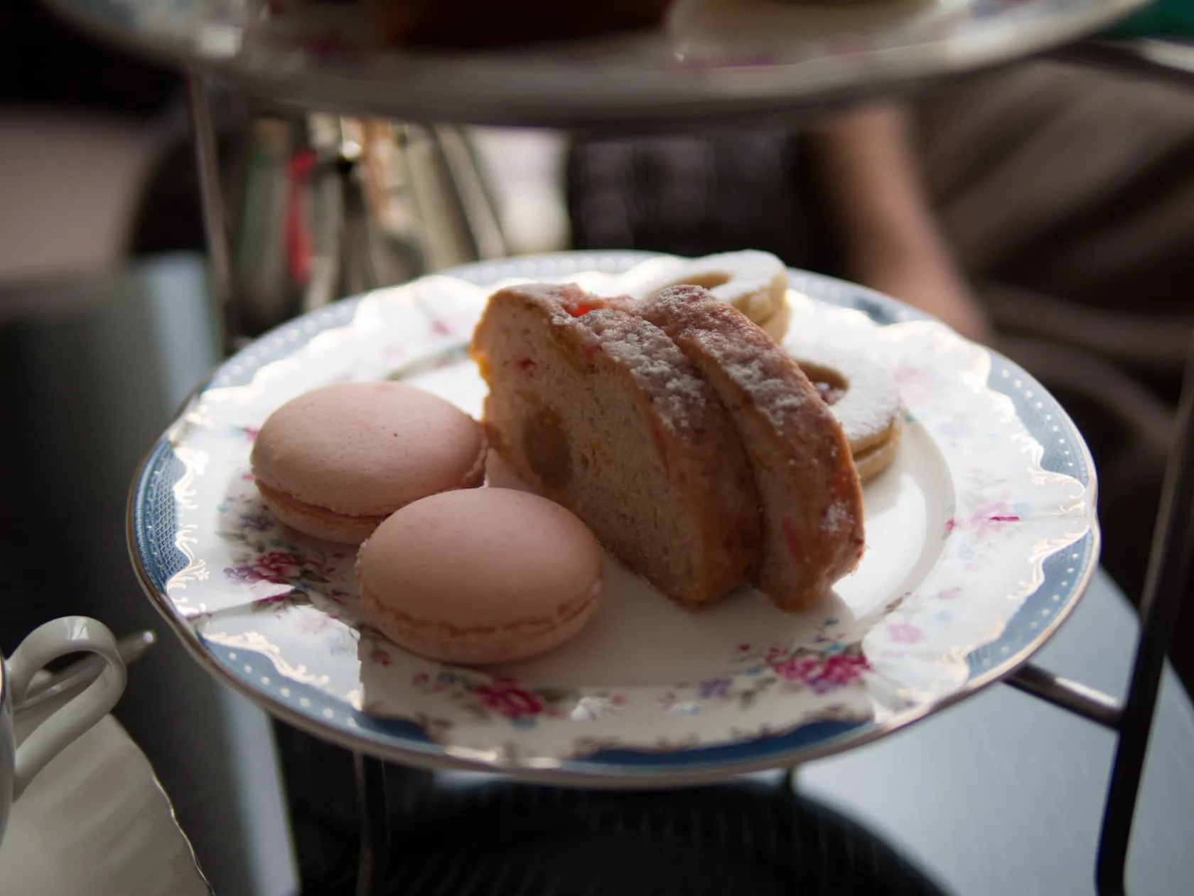 Pink macarons and sugar-dusted stollen on floral china at Carcosa Seri Negara