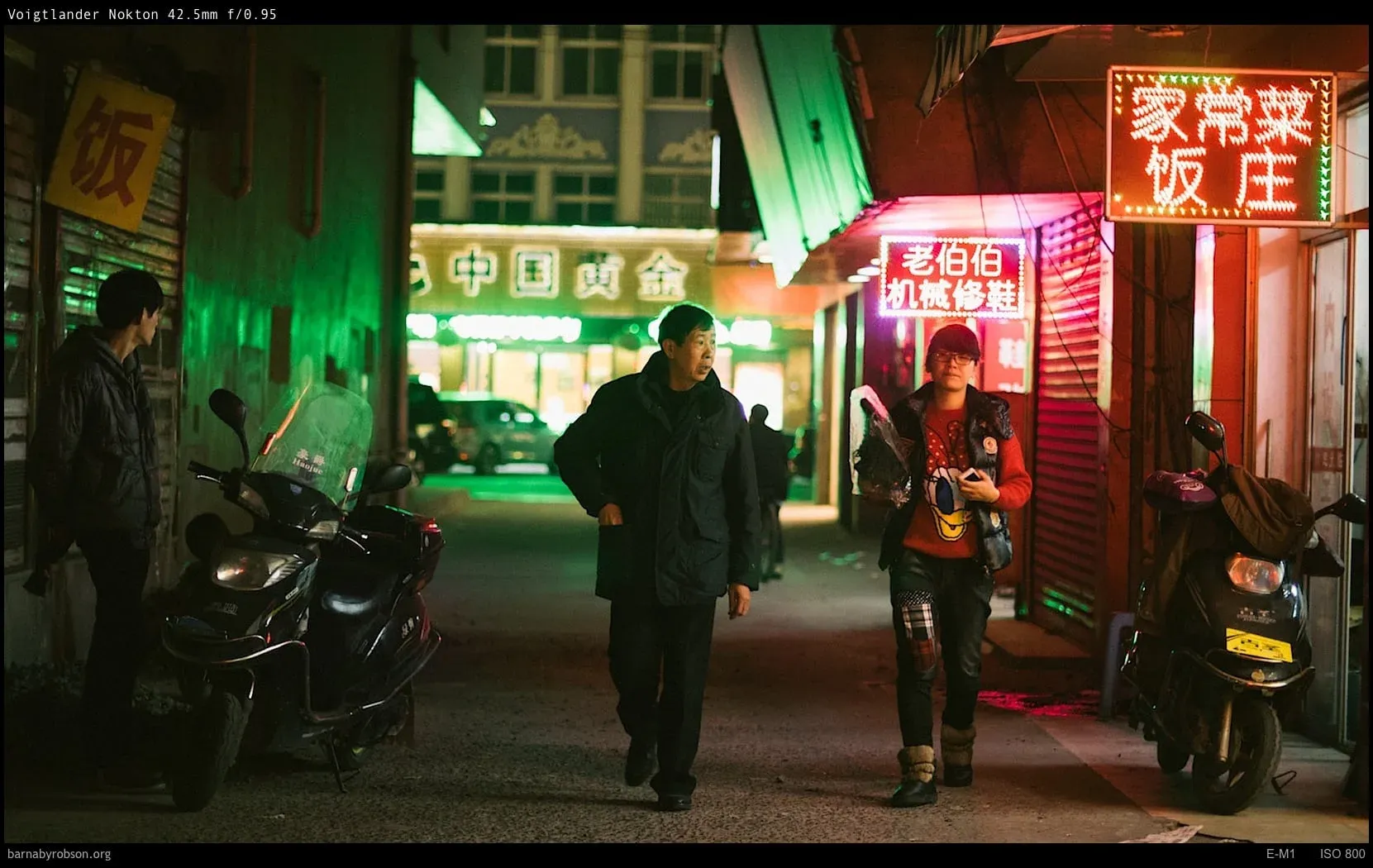 A neon-lit night street shot wide open on the Voigtlander Nokton f0.95.