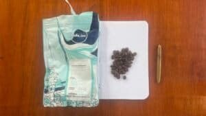 Rich, aromatic Arabica Sumbawa coffee beans from Barnaby Robson, displayed on a notepad with a gold pen for a sophisticated coffee experience. Perfect for coffee enthusiasts and connoisseurs.