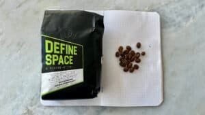 Bag of specialty coffee beans with "Define Space" label from Barnaby Robson, showcasing fresh roasted coffee, ideal for manual brewing and appreciated by coffee enthusiasts.