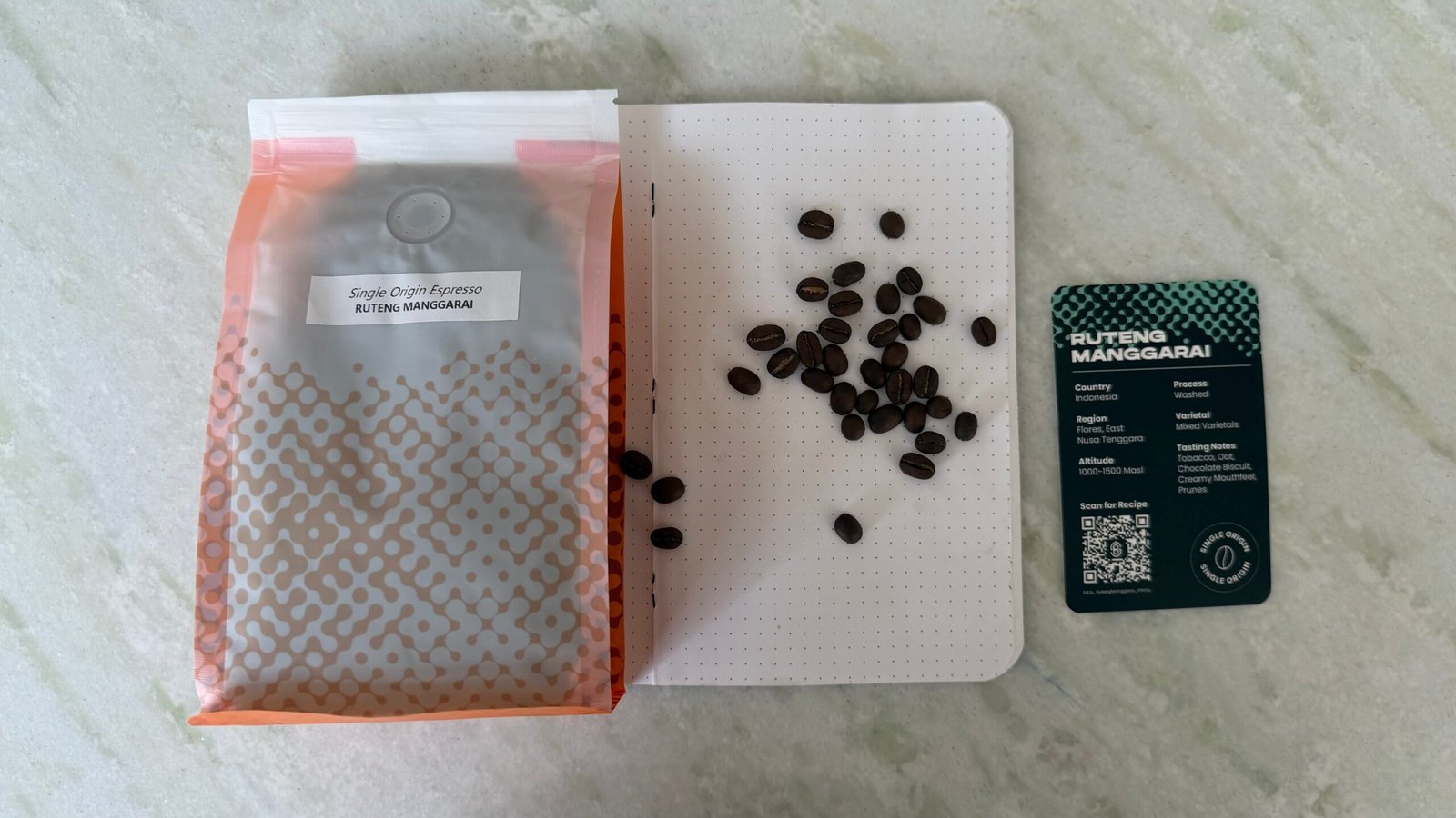 Rich, dark roasted single origin coffee beans from Ruteng Manggarai, Indonesia, shown alongside a tasting note card, for coffee enthusiasts and connoisseurs seeking authentic, high-quality Arabica beans.