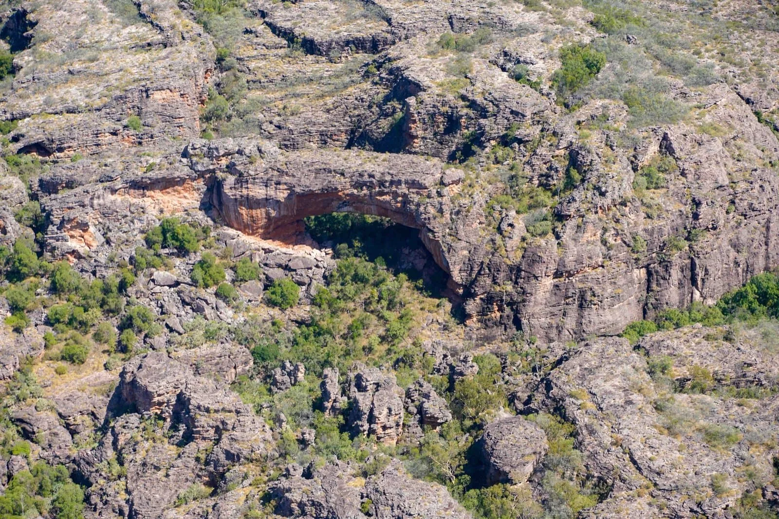 A natural rock arch seen from the air in Kakadu National Park.