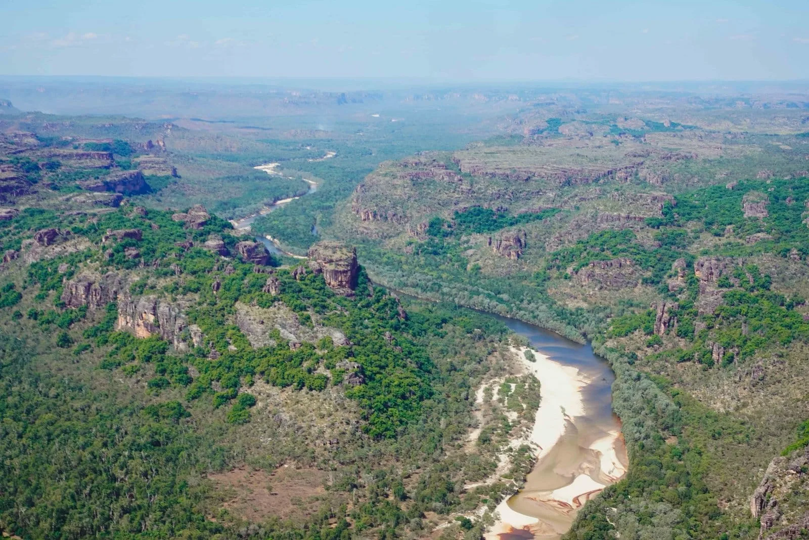 A river winding through Kakadu country beneath sandstone ridges.