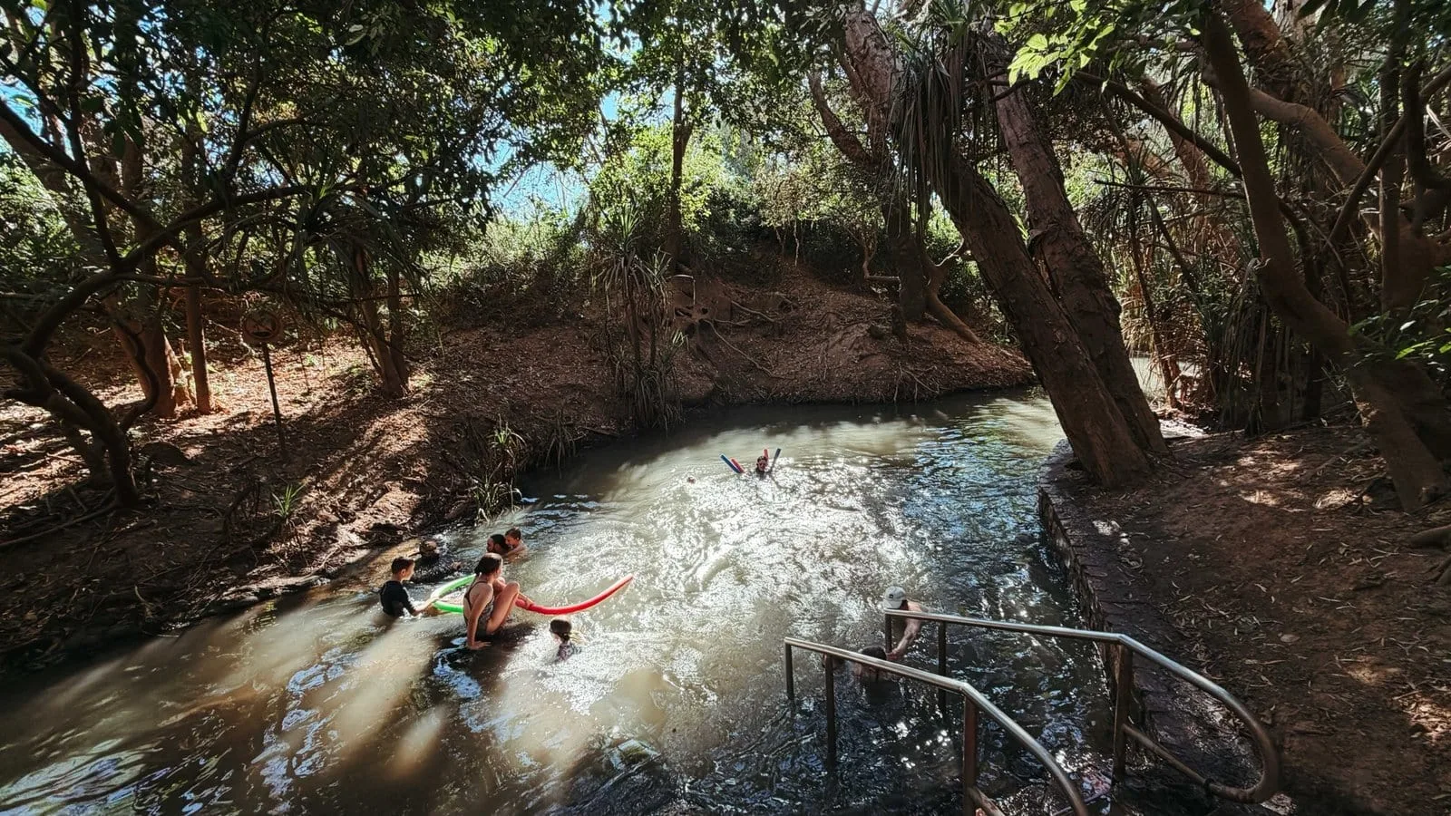 Swimmers in the pandanus-shaded pools at Katherine Hot Springs.